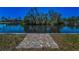 Picturesque water view with a brick walkway leading to the serene canal at 3133 Pineview Dr, Holiday, FL 34691