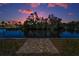A tranquil waterfront view with lush foliage and serene scenery at dusk at 3133 Pineview Dr, Holiday, FL 34691