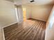 Bedroom featuring laminate flooring, white trim, and access to en suite bathroom at 3655 Dellefield St, New Port Richey, FL 34655