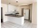 Kitchen with white cabinets, white appliances, and tiled flooring at 3655 Dellefield St, New Port Richey, FL 34655