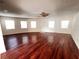 Spacious living room features gleaming hardwood floors, neutral walls, and plenty of natural light at 3655 Dellefield St, New Port Richey, FL 34655