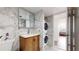 Modern bathroom features marble walls and floors, wood vanity and is equipped with a stacked washer and dryer at 400 Island Way # 210, Clearwater Beach, FL 33767