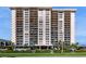 Luxury high-rise condo building featuring multiple stories, balconies, and covered parking at 400 Island Way # 210, Clearwater Beach, FL 33767