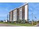 Exterior angle shot of a luxury high rise condo building with balconies and covered parking at 400 Island Way # 210, Clearwater Beach, FL 33767
