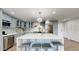 Charming kitchen with blue cabinets, modern appliances, and center island seating at 400 Island Way # 210, Clearwater Beach, FL 33767
