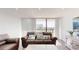 Bright living room features a comfortable sofa, entertainment center, and balcony access at 400 Island Way # 210, Clearwater Beach, FL 33767