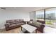 Bright living room with two sofas, coffee table, and balcony access, great for relaxing and enjoying the view at 400 Island Way # 210, Clearwater Beach, FL 33767