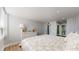 Bright main bedroom with a floral bedspread, ensuite bathroom, and a dresser with decor at 400 Island Way # 210, Clearwater Beach, FL 33767