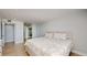 Bright bedroom with hardwood floors and a floral comforter set, and an ensuite bathroom at 400 Island Way # 210, Clearwater Beach, FL 33767