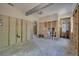 Unfinished living room with exposed framing, flooring and a decorative light fixture at 401 Patica Ne Rd, St Petersburg, FL 33702