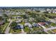 Aerial view of neighborhood with mature trees and community lake and golf course at 4148 102Nd N Pl, Clearwater, FL 33762