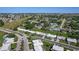 Wide aerial view of the neighborhood with nearby ponds and mature landscaping at 4148 102Nd N Pl, Clearwater, FL 33762