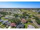 Aerial view of neighborhood with mature trees and community lake and golf course at 4148 102Nd N Pl, Clearwater, FL 33762
