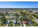 Aerial view of neighborhood with mature trees and community lake and golf course at 4148 102Nd N Pl, Clearwater, FL 33762