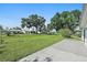 View of backyard featuring lush green grass and mature trees at 4148 102Nd N Pl, Clearwater, FL 33762