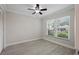 Bedroom with modern ceiling fan, light gray walls, wood-look tile flooring, and natural light from a window at 4148 102Nd N Pl, Clearwater, FL 33762