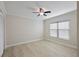 Bedroom with modern ceiling fan, light gray walls, wood-look tile flooring, and natural light from the window at 4148 102Nd N Pl, Clearwater, FL 33762