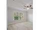 Bedroom featuring a ceiling fan, bright window, and wood-look tile flooring at 4148 102Nd N Pl, Clearwater, FL 33762