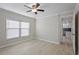 Bedroom with modern ceiling fan, light gray walls, wood-look tile flooring, and natural light at 4148 102Nd N Pl, Clearwater, FL 33762