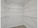 Walk-in closet featuring ample storage with white shelving and gray tiled floor at 4148 102Nd N Pl, Clearwater, FL 33762
