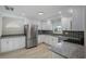 Modern kitchen featuring white cabinets, granite countertops, stainless steel appliances, and tile backsplash at 4148 102Nd N Pl, Clearwater, FL 33762