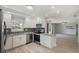 Bright kitchen with stainless steel appliances, granite countertops, and patterned backsplash open to the living area at 4148 102Nd N Pl, Clearwater, FL 33762