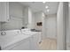 Well lit laundry room with washer, dryer, storage cabinets, and sink at 4148 102Nd N Pl, Clearwater, FL 33762