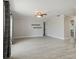 Large living room featuring wood-look tile flooring, neutral walls, and modern fixtures throughout at 4148 102Nd N Pl, Clearwater, FL 33762
