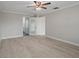 Spacious primary bedroom boasts wood-look tile flooring, a modern ceiling fan, and an ensuite bathroom at 4148 102Nd N Pl, Clearwater, FL 33762