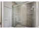 Modern shower with gray tiled walls and glass door at 4148 102Nd N Pl, Clearwater, FL 33762