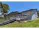 A home's backyard with a deck, a screened-in patio, and some green grass at 4226 Saltwater Blvd, Tampa, FL 33615