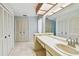 A bathroom with a large vanity, tiled floors, and multiple closets for ample storage at 4226 Saltwater Blvd, Tampa, FL 33615