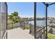 A grey wooden deck overlooks a canal, offering a peaceful view of boats and waterfront homes at 4226 Saltwater Blvd, Tampa, FL 33615
