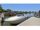 Stunning waterfront view showcasing a private dock with a sleek white boat against a backdrop of tranquil canal waters at 4226 Saltwater Blvd, Tampa, FL 33615