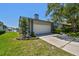 A single-Gathering home with an attached two-car garage, a well-manicured lawn and blue skies at 4226 Saltwater Blvd, Tampa, FL 33615