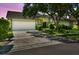 Charming home with lush front yard landscaping, a two car garage, and mature trees at 4226 Saltwater Blvd, Tampa, FL 33615