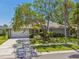 Charming single-story home with mature trees, lush landscaping, and a two-car garage at 4226 Saltwater Blvd, Tampa, FL 33615