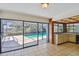Spacious kitchen featuring tile floors and direct access to a screened-in pool and patio area at 4226 Saltwater Blvd, Tampa, FL 33615