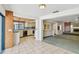 Open kitchen featuring tile floors and an adjacent living area with a fireplace at 4226 Saltwater Blvd, Tampa, FL 33615