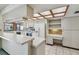 Bright kitchen featuring white cabinets, tiled floors, and an eat-in counter at 4226 Saltwater Blvd, Tampa, FL 33615