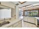 Clean eat-in kitchen features sleek white cabinetry and tile flooring with exterior view at 4226 Saltwater Blvd, Tampa, FL 33615