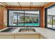 Bright kitchen with stainless sink and cooktop offers a view of the screened-in pool and canal at 4226 Saltwater Blvd, Tampa, FL 33615