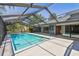A spacious screened-in pool with a large deck is surrounded by lush landscaping and offers ample space at 4226 Saltwater Blvd, Tampa, FL 33615