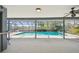 Relaxing screened in pool area with outdoor ceiling fan, and waterfront views at 4226 Saltwater Blvd, Tampa, FL 33615