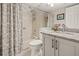 Clean bathroom features a shower over tub, granite vanity and gray cabinetry at 476 Santa Cruz Ne Pl # C, St Petersburg, FL 33703