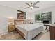 Bright bedroom with a ceiling fan, a comfortable queen bed, and a decorative painting at 476 Santa Cruz Ne Pl # C, St Petersburg, FL 33703