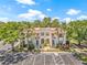 Aerial view of a condo showcasing its well-maintained facade, landscaping, and ample parking at 476 Santa Cruz Ne Pl # C, St Petersburg, FL 33703