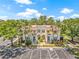 Aerial view of a condo showcasing its well-maintained facade, landscaping, and ample parking at 476 Santa Cruz Ne Pl # C, St Petersburg, FL 33703