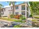 Well-maintained condo exterior with lush landscaping, private balcony, and convenient parking spaces at 476 Santa Cruz Ne Pl # C, St Petersburg, FL 33703