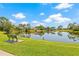 Scenic view of the pond with bench and surrounding trees on a sunny day at 476 Santa Cruz Ne Pl # C, St Petersburg, FL 33703